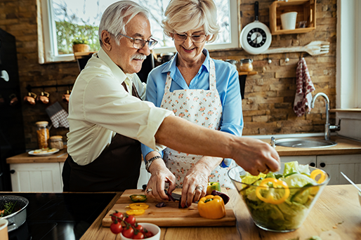 mature couple making salad