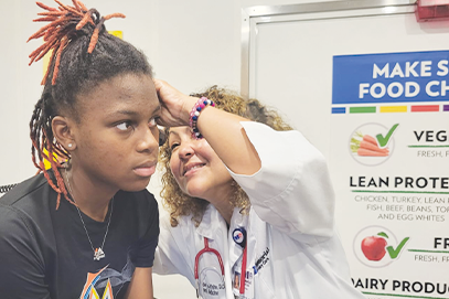 Dr. Perla Del Pino-White examining TaNya's ear